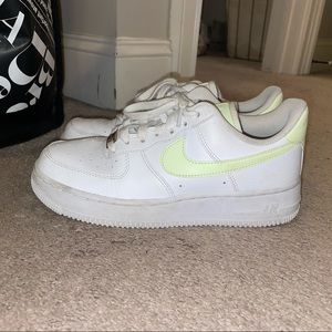 Nike Air Force 1’s with neon yellow Nike sign.